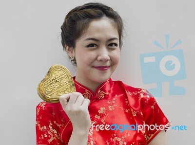 Asian Woman Holding Golden Heart Stock Photo