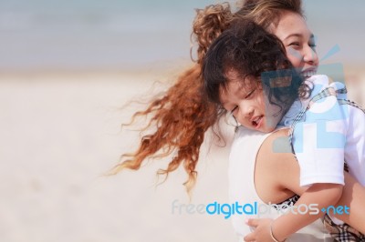 Asian Woman Holding Her Son Stock Photo