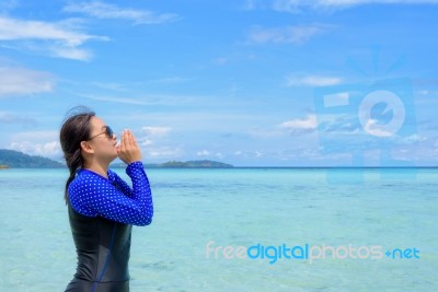 Asian Woman Shouting With Hands On The Sea In Summer, Thailand Stock Photo