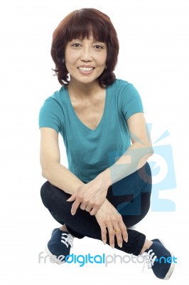 Asian Woman Sitting On Floor Stock Photo