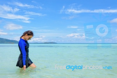 Asian Woman Walking In The Sea At Travel To Koh Lipe Island Stock Photo