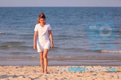 Asian Woman Walking On Beach Stock Photo