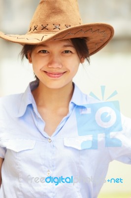 Asian Woman Wearing Cowboy Hat And Smiling Stock Photo