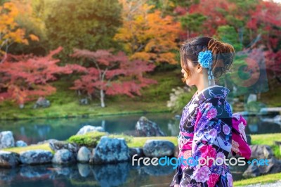 Asian Woman Wearing Japanese Traditional Kimono In Autumn Park. Japan Stock Photo