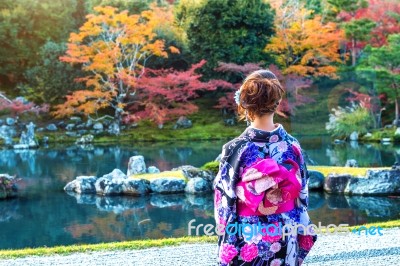 Asian Woman Wearing Japanese Traditional Kimono In Autumn Park. Japan Stock Photo