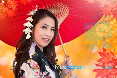 Asian Woman Wearing Kimono In Autumn Stock Photo