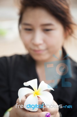 Asian Women Black Shirt. Holding White Flower Stock Photo