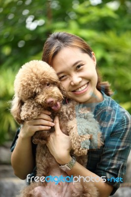 Asian Women Hug With Poodle Dog  I Stock Photo