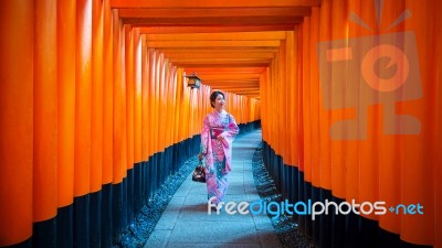 Asian Women In Traditional Japanese Kimonos At Fushimi Inari Shrine In Kyoto, Japan Stock Photo