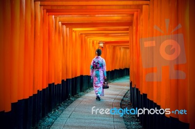 Asian Women In Traditional Japanese Kimonos At Fushimi Inari Shrine In Kyoto, Japan Stock Photo