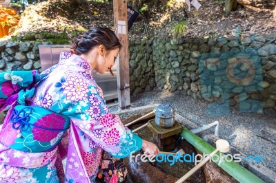 Asian Women In Traditional Japanese Kimonos At Fushimi Inari Shrine In Kyoto, Japan Stock Photo