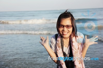 Asian Women Smiling Happily At The Beach Stock Photo