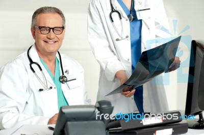 Assistant Presenting X Ray Report Stock Photo