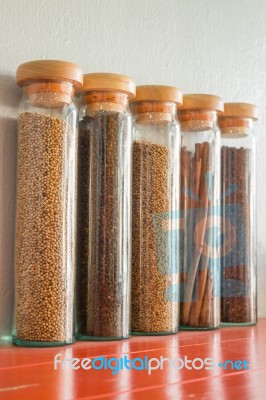 Assortment Of Spices In Glass Bottles Stock Photo