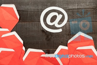 At Sign And Red Envelopes On Wooden Background Stock Photo