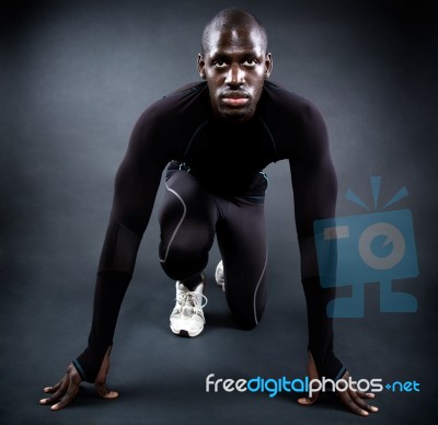 Athletic Man Running In Black Background Stock Photo