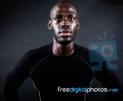 Athletic Man Running In Black Background Stock Photo