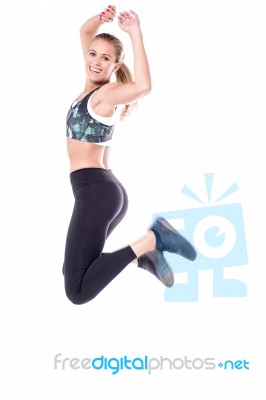 Athletic Woman Jumping High Stock Photo