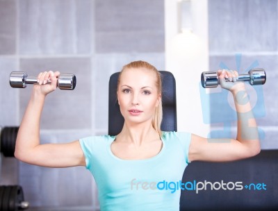 Attractive Blond 
 Sporty Girl Doing Shoulders Training Wi Stock Photo