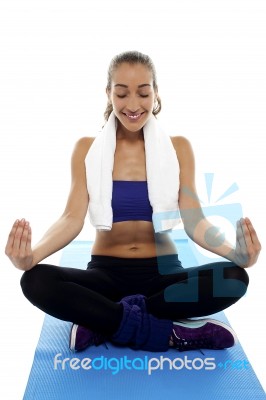 Attractive Brunette Meditating In Lotus Posture Stock Photo