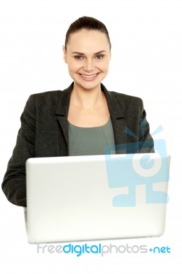 Attractive Corporate Female Working On Laptop Stock Photo