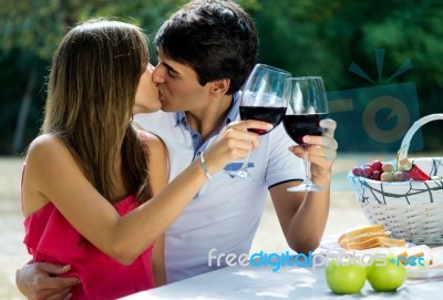 Attractive Couple Drinking Wine On Romantic Picnic In Countrysid… Stock Photo