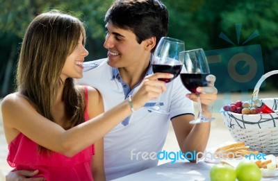 Attractive Couple Drinking Wine On Romantic Picnic In Countrysid… Stock Photo