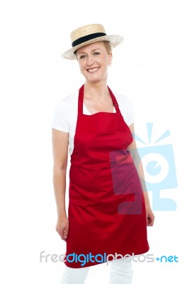 Attractive Female Chef Wearing Red Apron And Hat Stock Photo