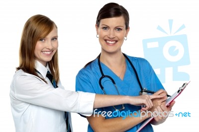 Attractive Girl Pointing At The Doctors Case Sheet Stock Photo