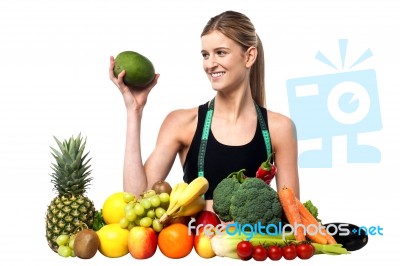 Attractive Girl With Heap Of Fruits And Vegetables Stock Photo