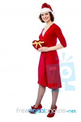 Attractive Lady In Red Attire With Xmas Gift Stock Photo