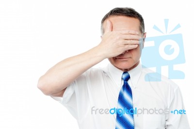 Attractive Male Cover Eyes With His Hands Stock Photo