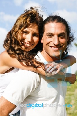 Attractive Man Carrying Woman Stock Photo