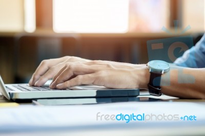 Attractive  Man In Casual Business Sitting At A Table Working On… Stock Photo