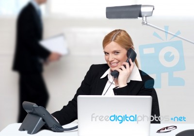 Attractive Secretary Attending Phone Call Stock Photo