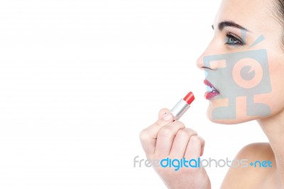 Attractive Teen Girl Applying Red Lipstick Stock Photo