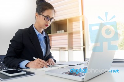 Attractive Women In Casual Business Sitting At A Table Working O… Stock Photo