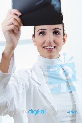 Attractive Young Female Doctor Examining X-ray Results Stock Photo