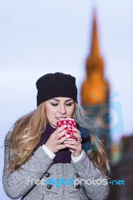 Attractive Young Stylish Blonde Girl Drinks Hot Drink From A Mug… Stock Photo