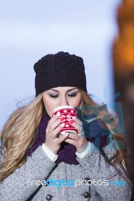 Attractive Young Stylish Blonde Girl Drinks Hot Drink From A Mug… Stock Photo