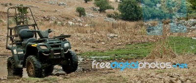 ATV Standing In Muddy Stock Photo