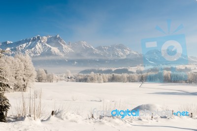 Austrian Winter Wonderland With Mountains, Fresh Snow And Haze Stock Photo