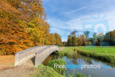 Autumn Forest Landscape With Wooden Bridge Over Water Stock Photo