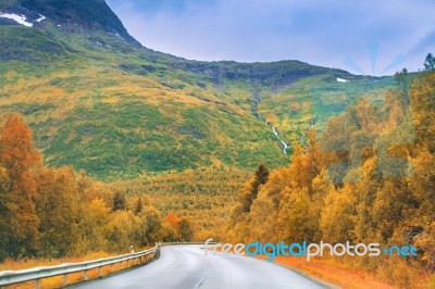 Autumn Road In Mountains Stock Photo