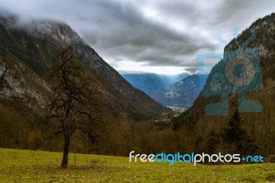 Autumn Valley In The Alps With Sunlight Breaking Through Stock Photo