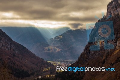 Autumn Valley In The Alps With Sunlight Breaking Through Stock Photo