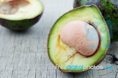 Avocado Cuts On Wooden Stock Photo