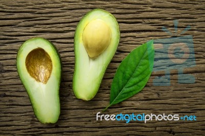 Avocado On A Brown Wood Background Stock Photo