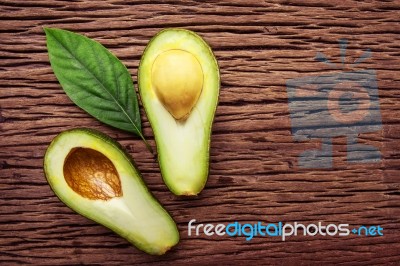 Avocado On A Brown Wood Background Stock Photo