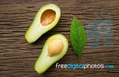 Avocado On A Brown Wood Background Stock Photo